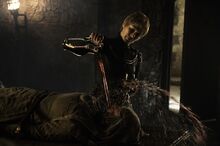 Cersei pouring wine over the face of the bound Unella.