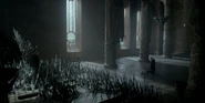 Viserys confronts Daemon in from of the Iron Throne.