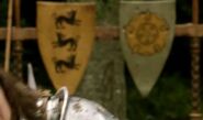 A shield emblazoned with the sigil of House Tyrell (right) on display at the Tourney of the Hand in "The Wolf and the Lion".