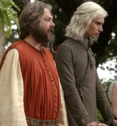 The undercoat that Viserys wears: note that it still has an asymmetric cut along its entire length, and a high embroidered collar.