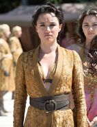 High-resolution image of Obara Sand in her formal wear: Obara is the most martial of the Sand Snakes, and on this rare occasion that she can't wear leather armor (because it would be inappropriate), she nonetheless outright wears men's clothing, the same kind of Dornish overcoat her father wore. Note the snake decorations on her belt buckle.