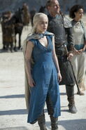 Daenerys at the Siege of Meereen in Season 4, back in her signature blue riding dress. Notice the Dothraki-style leather riding chaps which she anachronistically wears underneath her skirt. Note her mother's ring on her left index finger.
