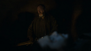 Davos sits by Jon Snow's body.