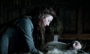 Catelyn Stark tending to an unconscious Bran in "The Kingsroad." She refused to leave Bran's side for weeks after his injury.