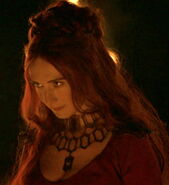 Melisandre of Asshai. Notice that her elaborate necklace has a repeating motif of elongated hexagons, part of the Asshai-style.