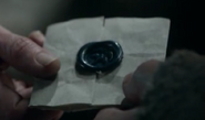 Maester Luwin delivering Lysa's letter to Catelyn, the seal bearing the imprint of a falcon in blue wax, in "Winter Is Coming".