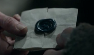 Meister Luwin delivering Lysa's letter to Catelyn, the seal bearing the imprint of a falcon in blue wax, in "Winter Is Coming".