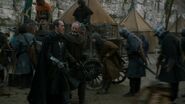 Stannis walking through camp, with his armor and cloak