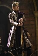 Joffrey is vain and foppish, dressing in the most fashionable clothing, with gold tracery and silk sashes. He is trying to convince everyone around him that he is a king by looking like one.