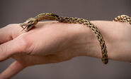 Behind the scenes closeup of the highly detailed gold bracelet that Ellaria wears in Season 5, shaped like a hissing snake.