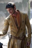 Oberyn's clothing is decorated with a repeated motif of the sunburst-pierced-by-a-spear sigil of House Martell