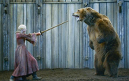 Bolton's men torture Brienne by throwing her into a bear pit, wearing the pink dress they gave her