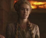 Another intermediate stage, pink dress when Cersei dismisses Barristan Selmy. Even before she wears large metal collars, Cersei always wears large metal Lannister lion pendants (like armor); she also wears a lot of jewelry to show off her wealth as a Lannister and queen.