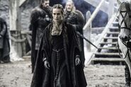 Stannis's wife Queen Selyse Baratheon, wearing traveling clothes at Castle Black in Season 5. Note the Baratheon stag-head jewelry on her belt (high definition image, click to expand).