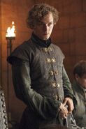 Loras Tyrell wearing the Reach-style of men's clothing. In specific contrast with the Lannisters' style, it has a symmetrical cut.