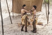 Side view of Nymeria and Tyene: their costumes have backless halter tops, leaving their backs uncovered in Dorne's heat. Note in this shot that the Sand Snakes all wear suede riding pants and leather boots, ready for a fight. Also clearly visible here are the Sand Snakes' curled boots.