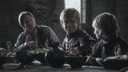 Tommen sitting next to his uncle Tyrion, and his biological father Jaime, in "The Kingsroad."