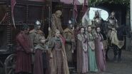 Cersei's handmaidens when she arrives at Winterfell (at right) emulate her style of dress, as well her formal hairstyle (a heavily braided fan shape).