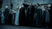 Luwin stands behind the Stark family as they await the arrival of the king in "Winter Is Coming".