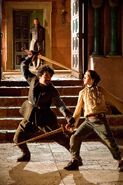 Arya trains with Syrio as Eddard Stark watches.