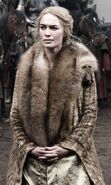 The first costume Cersei is seen in: a large fur traveling coat when arrives at Winterfell, in the cold north (perhaps meant to hide the actress's pregnancy)