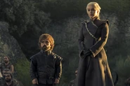 Tyrion and Daenerys stand before them.