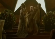 Joffrey takes off his cloak and gets ready to put it on Margaery