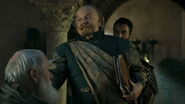 Mace Tyrell at the Small Council in Season 5: after Tywin dies, the Tyrells subtly shift to dressing in more imposing fashion. Mace now wears a bold green tunic instead of soft teals, with no gold tracery. The only part of his costume with gold tracery on teal is now an imposing sash - not the humble appearance he had when Tywin was alive.
