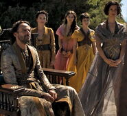 Prince Doran makes the Sand Snakes officially see off Myrcella and Jaime as they leave Dorne, and they have to switch to more formal dress for the occasion. Ellaria here wears another frequently seen dress style for Dornish women: light material unafraid to almost fall off the shoulders, and then and gauzy enough that her legs can be seen through it.
