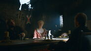 A House Bolton sigil displayed behind Jaime Lannister and Brienne of Tarth as they dine with Lord Roose Bolton
