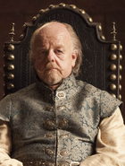 Lord Mace Tyrell, father of Margaery and Loras, son of Olenna. He wears the same Reach-style of men's clothing that Loras does. Note that in Season 4, the Tyrell men still wear softer teal colors with light gold tracery, to make them seem less intimidating.