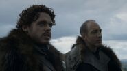 Roose Bolton wears his fur cloak with the collar reversed.
