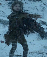 Leaf saving Bran Stark from wights at the entrance to the cave of the Three-Eyed Raven. Note the pattern of white spots or stripes on her legs in this image.