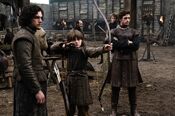 Jon Snow and Robb Stark watch their brother Bran practicing archery.