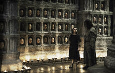 Jaqen and Arya walk through the Hall of Faces