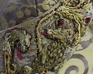 Embroidery on Sansa's wedding dress of a Lannister lion defeating a Stark direwolf.