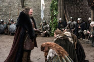 Robert is greeted by House Stark on his arrival in "Winter is Coming".