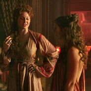 Ros and Daisy; in Season 2 Ros starts wearing better-quality gowns - which are basically knockoff imitations of the fashions that Cersei sets at the royal court. Notice the same asymmetrical kimono-like cut. She can't afford metal belts like a noblewoman, but she still imitates that look using heavy rope belts.