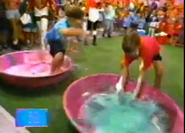 Here is the water balloon game where the red team and blue team square off. The teams have to pop balloons made of gloop. Pretty messy, right?