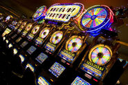 A large row of Wheel of Fortune slot machines.