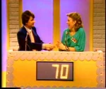 At the end of Round 1, Fred Grandy and his partner scored 70 points by answering seven questions correctly.
