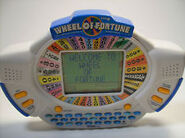 1999. 2nd Edition Handheld Game with "Welcome to Wheel of Fortune" opening signature on it. This game comes complete with a spin lever, a larger screen for bigger puzzles, a used letter board & a alphabetical order keyboard.