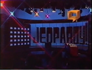 The 1990 Super Jeopardy! Set, completely darkened. The closed-captioning icon is the same one ABC used from the late 80's to the early 90's and was also used on the Season 11 intro for sister show Wheel of Fortune.