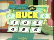 The current Pass the Buck game board using 6 numbers instead of 8. Note that the spaces where #'s 1 and 2 originally were are replaced with dollar bill graphics, as stated above.