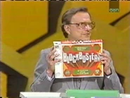 Bill Cullen shows off the BLOCKBUSTERS home game.