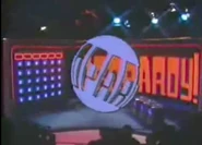 The logo was changed to its current form when the show returned in syndication in 1984 with Alex Trebek hosting. During Season 1 of the syndicated version, the logo was rotating around a blue globe superimposed on the screen.
