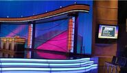 The contestant podiums. To the right is a monitor displaying the slate for that particular show, though the monitor is actually for the audience to view all the action. This was taken during the taping of the 32nd season premiere