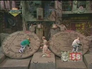 Game.jpg (15 KB) Here are two opposing players running on giant cardboard pendants of life. Whoa! Just those two contestants running around on those pendants of life are making me very dizzy!