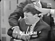 Marty Allen is restrained by Allen Ludden and smacked by Steve Rossi while giving a clue for BLUSH.