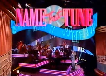 Name That Tune Game Shows Wiki Fandom An interactive dvd game, you'll get to watch hundreds clips on your tv as you answer over 1,000 questions about the music from your favorite decade. name that tune game shows wiki fandom
